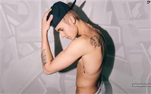 Justin Bieber flaunts his tattoos while posing shirt-less